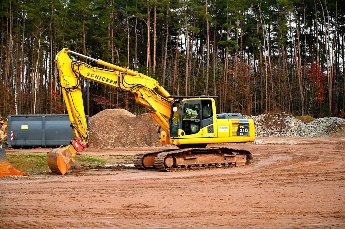 Excavator performing site earthworks and land clearing
